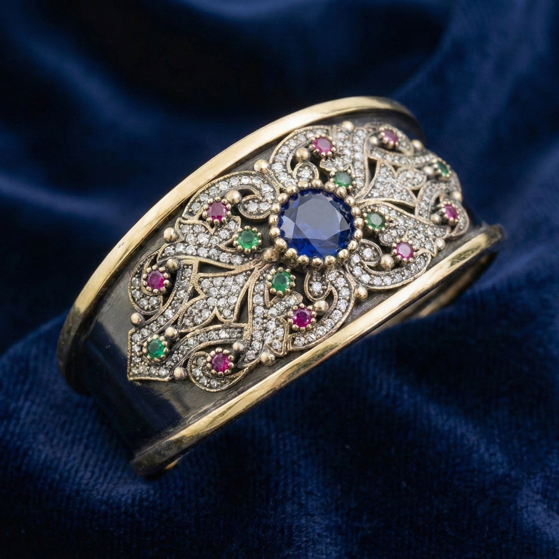 Decorative bracelet with gemstones on a blue fabric background