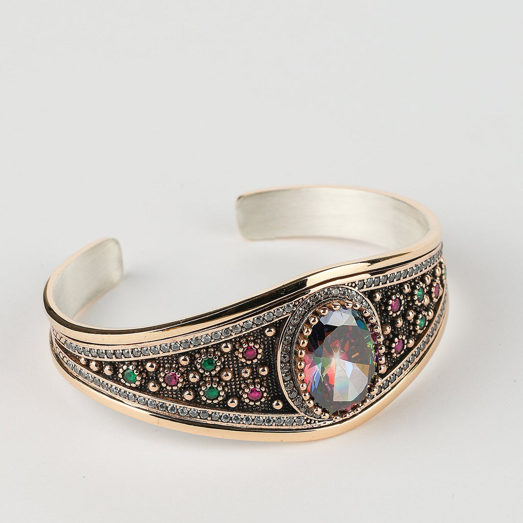 Silver bracelet with gemstone accents on a light gray background