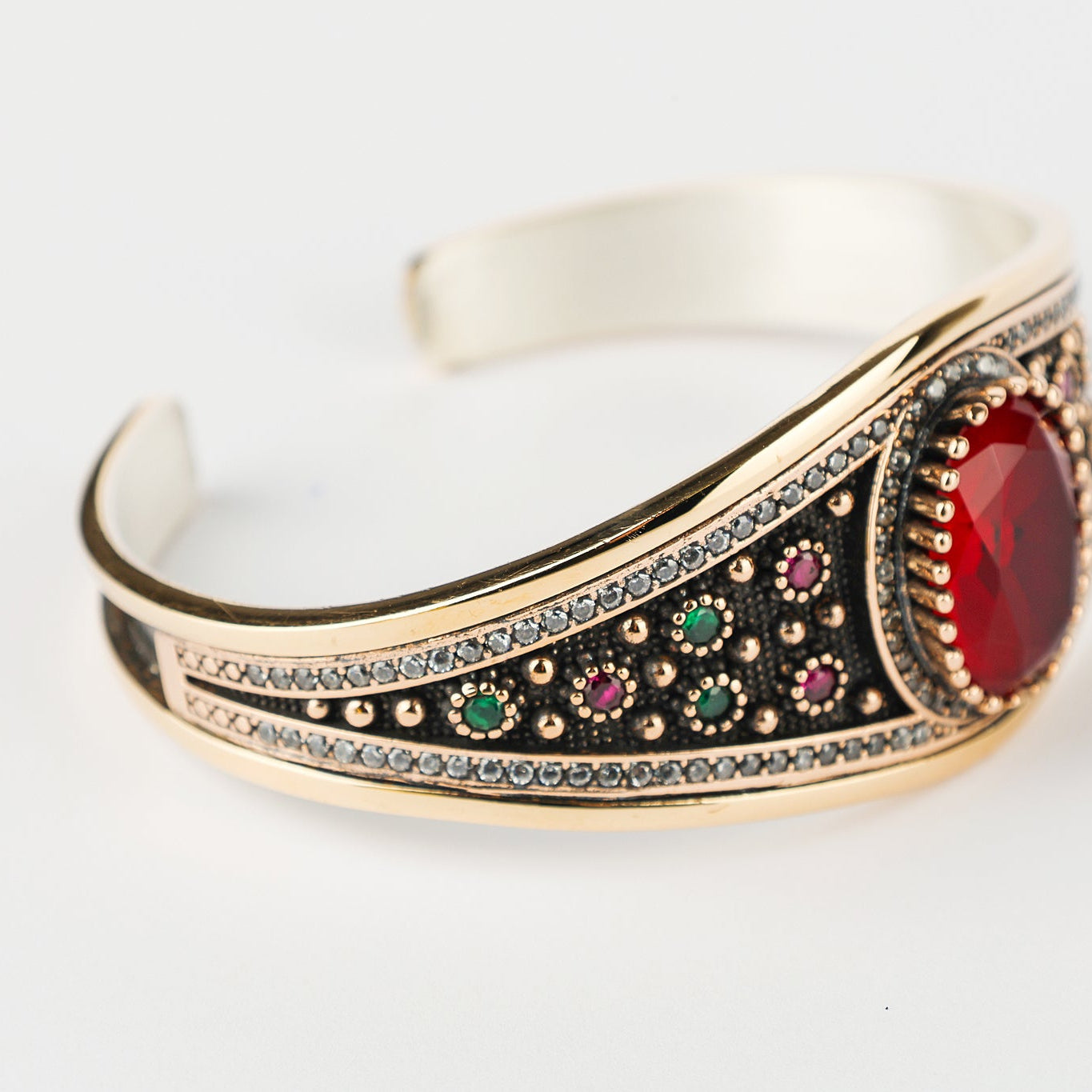 Decorative bracelet with gemstones on a white background