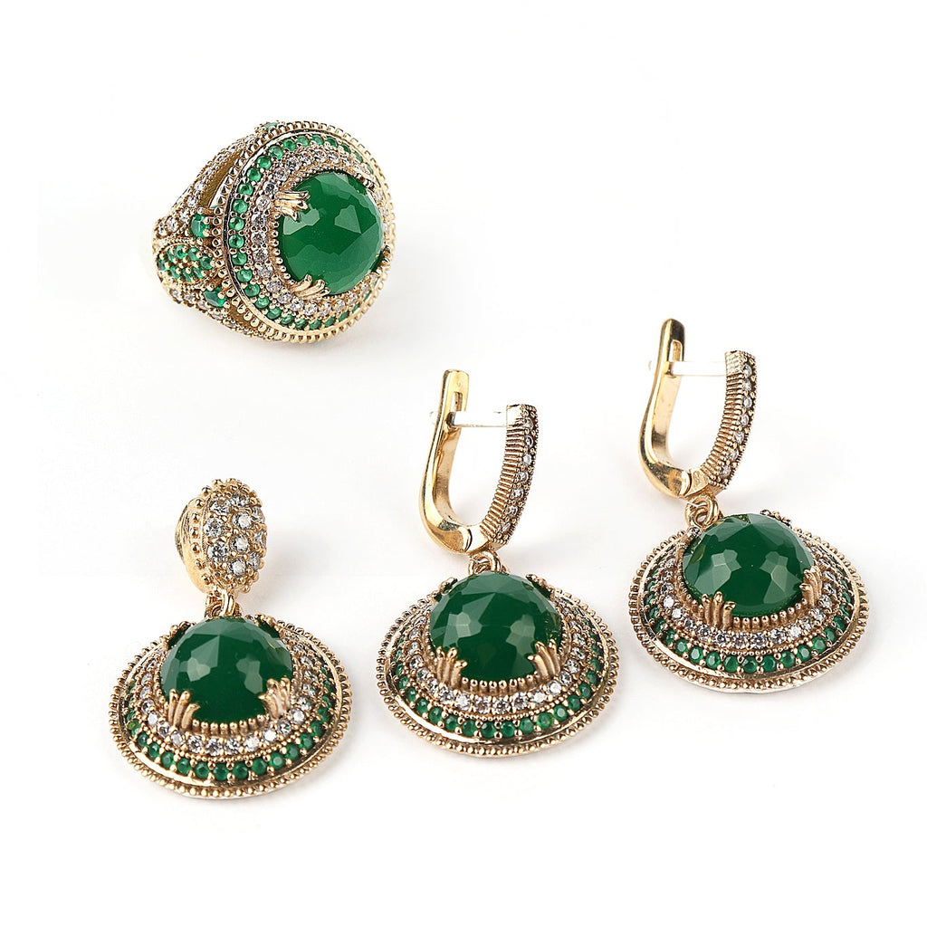 Set of green gemstone earrings with gold accents on a white background