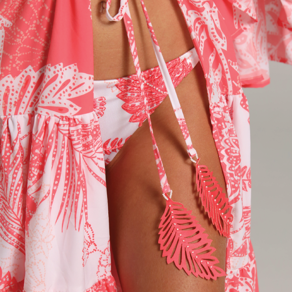 Pink and white floral bikini with matching cover-up on a neutral background