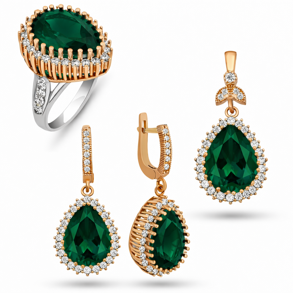 Jewelry set with emerald green gemstones and gold accents on a white background