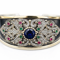 Decorative bracelet with gemstones on a white background