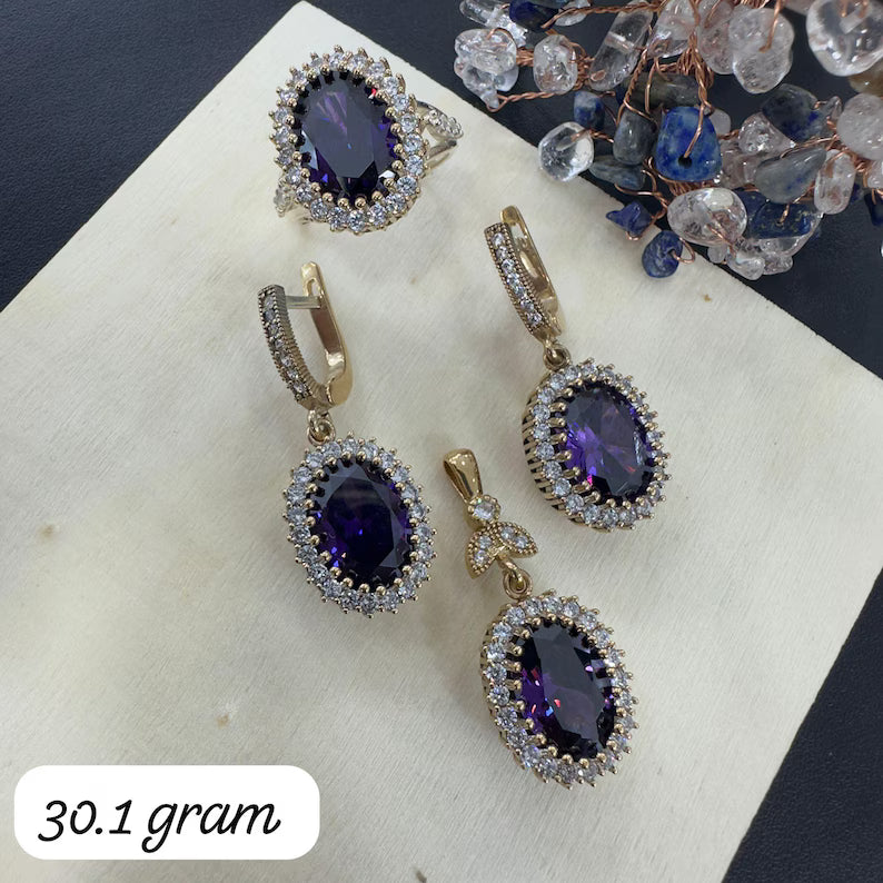 Jewelry set with purple gemstones on a white surface