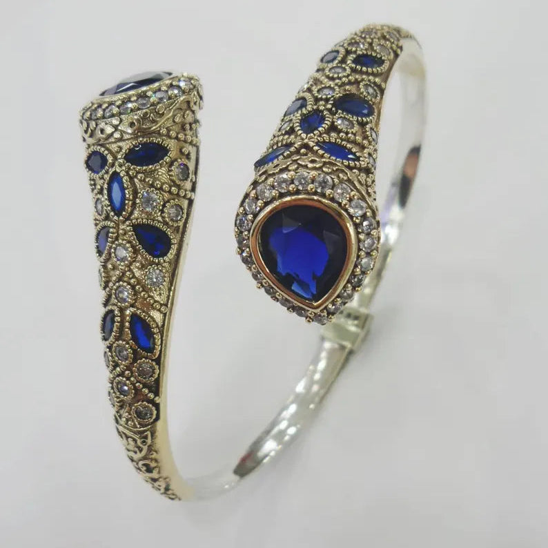 Silver bracelet with blue gemstones on a light gray background
